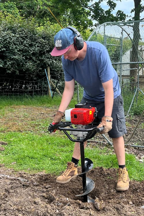 photo of a man operating an auger