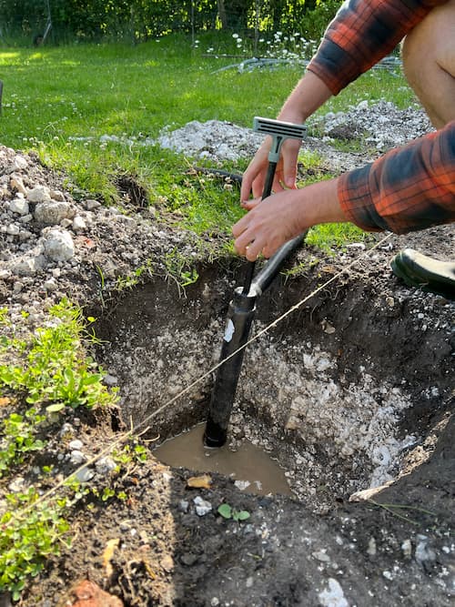 photo of a bilge pump in a post hole