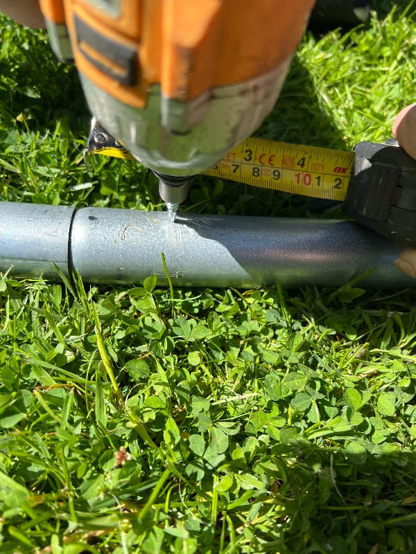 photo of driving a self tapping screw into the polytunnel frame
