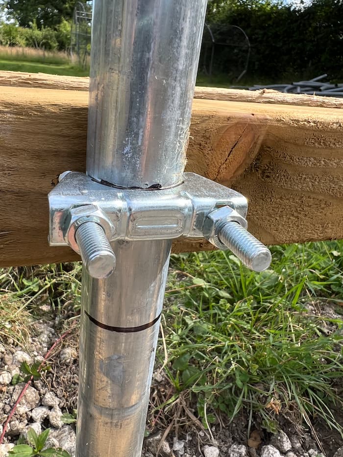photo of collars used to attach wooden rails to metal pipes